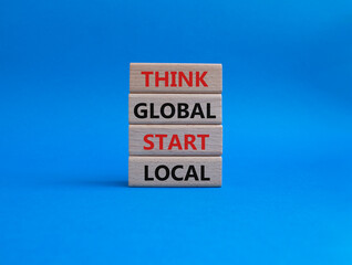 Think global act local symbol. Wooden blocks with words Think global act local. Beautiful blue background. Business and Think global act local concept. Copy space.