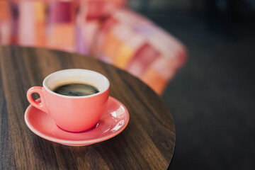 Cup of black coffee on a table in a cafe.