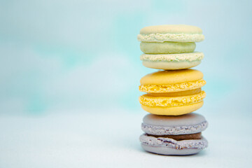 Low angle view of three fresh colorful macaroons with pastel background
