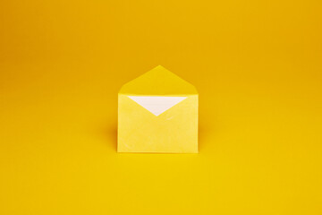 Yellow color paper office envelope with white lined sheet with copy space isolated on the bright...