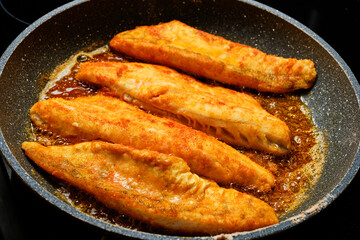 Cooking fish on frying pan