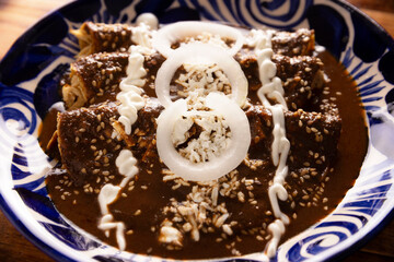 Chicken enmoladas. Also known as mole poblano enchiladas, they are a typical Mexican dish that is very popular in Mexico and the rest of the world.