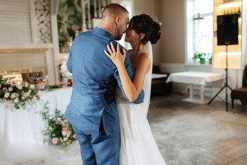 the first dance of the bride and groom inside a restauran