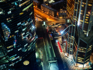 above view of street and illuminated glass towers in Moscow city business district in evening from Imperia Tower
