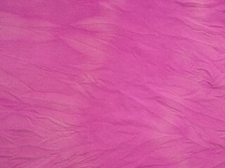 textile background - crushed silk fabric dyed in purple with tie-dye stains at home