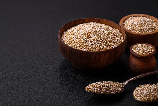 Wholesome raw quinoa in a bowl on a dark concrete background