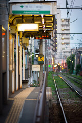 Tokyo Shitamachi trolly train (Toden) running in middle of city businesses and homes