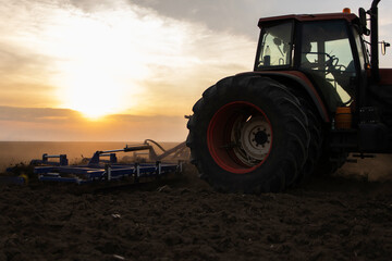 Obraz premium Farmer preparing his field in a tractor