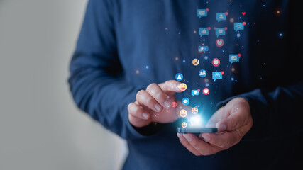 Hand holding smartphone and Social media and digital online concept, Man using smart phone with Social media.  Man using social media and digital online, online marketing, technology network concept.