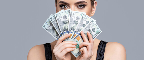 Luxury, beauty and money concept. Girl holding cash money in dollar banknotes. Woman holding lots...