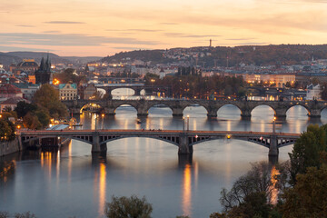 Fototapeta na wymiar Lookout after sunset. Illuminated Prague. Scenic view of bridges on the Vltava river and of the historical center of Prague: buildings and landmarks of old town. Carlsbridge