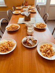 school lunch table with pasta, bun and milk