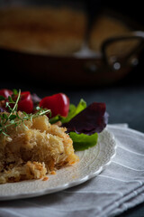 Salt cod brandade garnished with thyme. Salt cod is blended with potatoes, milk, garlic, and olive oil, then baked in a casserole or au gratin pan.