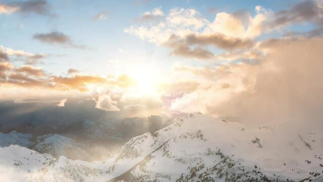 Snow and Cloud covered Canadian Mountain Landscape Nature Background. Dramatic Sunset Sky Art Render. Cinemagraph Continuous Loop Animation. Near Vancouver, British Columbia, Canada. Aerial
