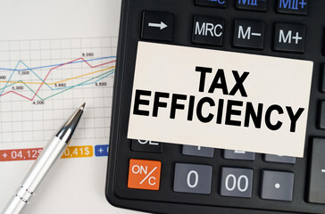 On the business chart lies a pen, a calculator and a business card with the inscription - Tax Efficiency