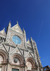 Fototapeta na wymiar Facade of Cathedral of Siena in Tuscany Region in Italy