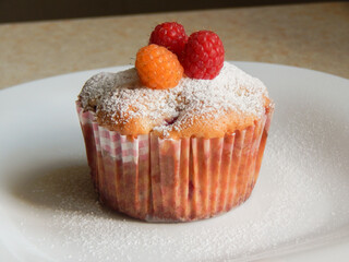Raspberry cupcake. Cupcake with raspberries. Juicy, fresh, tasty, sweet. Homemade delicious cupcake with raspberries.