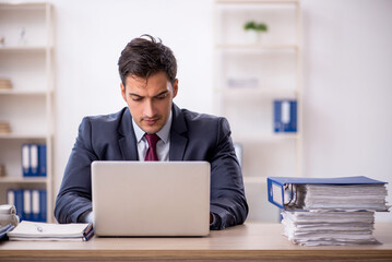 Young male employee working in the office