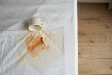  top view of coffee spilled on bed 