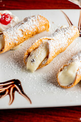 Cannoli. Classic traditional Italian dessert. Italian pastries made with tube-shaped shells of fried pastry dough filled with a sweet, creamy ricotta filling. Traditional Sicilian dessert.