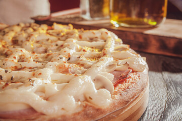 Brazilian pizza with mozzarella, pork loin, mushroons, catupiry and oregano (Pizza especial) - Closeup.