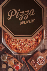 Brazilian pizza with tomato sauce, mozzarella, bacon and oregano in a delivery box (Pizza de bacon) - Top view.