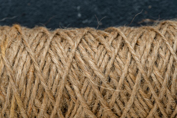 Natural jute twine skein, closeup. Spool of linen rope texture on background