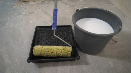Stir the white primer to the desired consistency. Water is poured into the primer. The primer is...