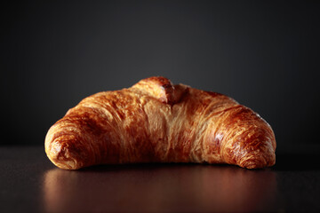 Croissant on a black ceramic table. Traditional French kitchen.