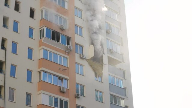 Kyiv, Ukraine - November 15, 2022: Fire in an apartment building, firefighters fighting the flames, burning house, fire disaster and accident tragedy concept.