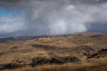 rocky landscape with moody storm and clouds 