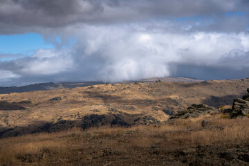 Fototapeta na wymiar rocky landscape with moody storm and clouds 