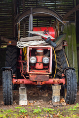 An older model European farm tractor in a shipyard in the industrial area in the Port of Hamburg 