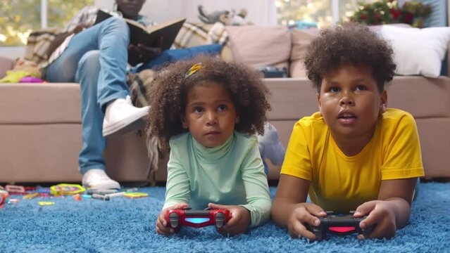African-American father babysit children playing video game. Realtime