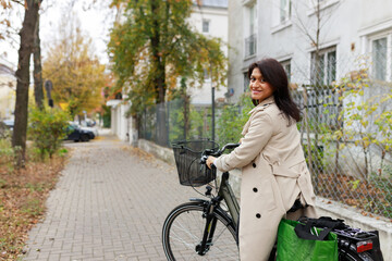 smiling woman riding a bicycle in the city