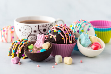 Hot chocolate bombs with marshmallows and sprinkles for Easter.