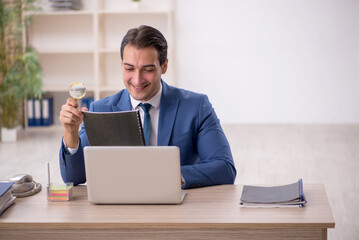 Young male employee working in the office