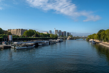 Obraz premium River Seine In Paris With Promenade, Anchored And Modern Office Buildings