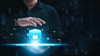 Cybersecurity concept, personal data protection and network security. Businessman holding key protecting business and financial data on tablet, secure internet access, security encryption.