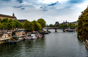 River Seine From Pont Neuf With Ships and Bridge Pont Des Arts In Paris, France