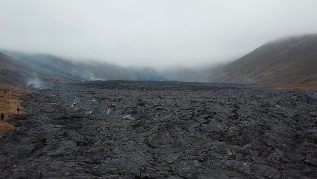 4K Aerial Drone footage of Cold Lava in Fagradalsfjall active volcano in Geldingadalir, Reykjanes, Iceland. River of Cold Lava Flowing down the hill. Lava field.