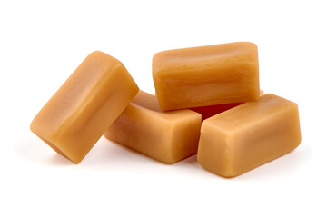 Caramel candies with caramel sauce, isolated on white background.