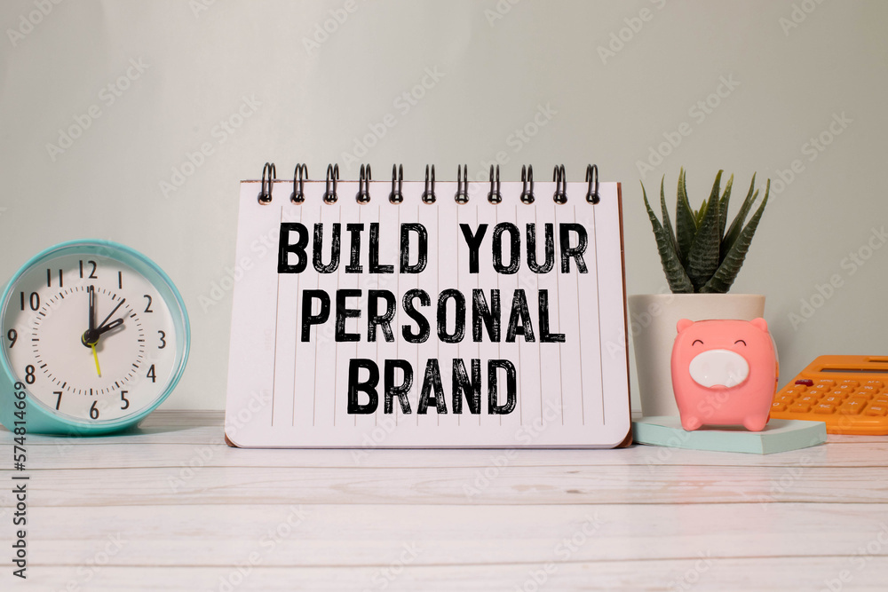 Poster build your brand typed on yellow paper on top of computer keyboard