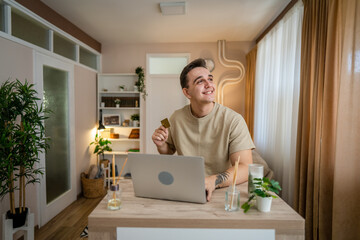 Fototapeta premium happy man online shopping use credit card laptop computer at home