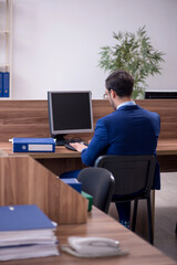 Young male employee working in the office