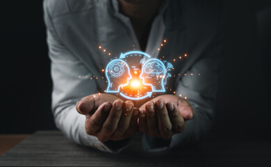 Close up of businessman hand holding brain in palm, Virtual reality man with symbol neurons in the brain. Concept of idea and innovation, on wooden table.