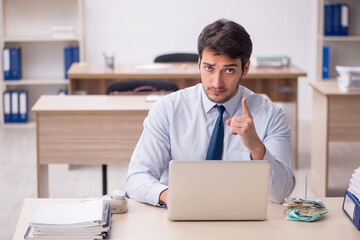 Young male employee working in the office