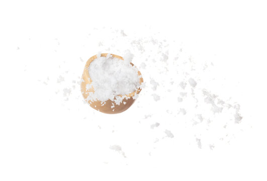 Refined Salt fall down pouring in wooden bowl, powder white salts explode abstract cloud fly. Small ground salt splash in air, food object element design. White background isolated high speed freeze