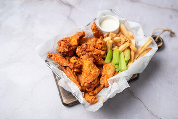 Buffalo chicken wings with celery and dip