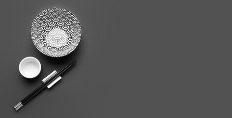 Chinese bowls with chopsticks on dark background with space for text